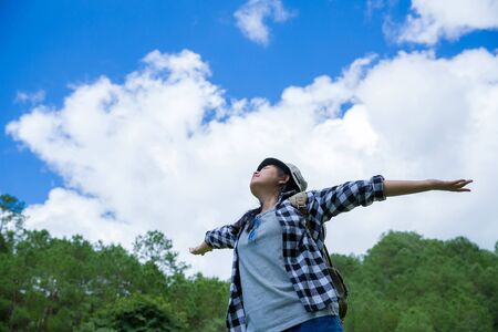 young women, look at the amazing mountains and forests, wanderlust travel ideas, space for messages, great moments of the atmosphere.の写真素材