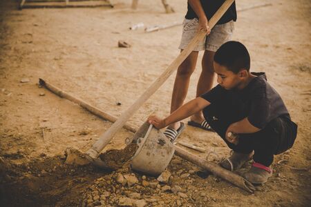 Against child labor, Poor children, construction work, labor work in the construction site,  Violence children and trafficking conceptの写真素材