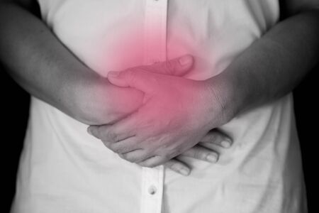 Stomach pain. Worried mature woman touching bellyの写真素材