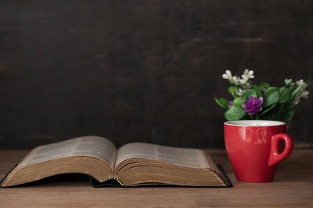 Bible and a cup of coffee for morning dedication on a wooden tableの写真素材
