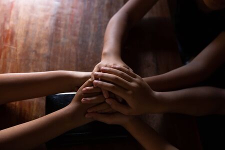 Christians are congregants join hands to pray and seek the blessings of God, the Holy Bible.の写真素材