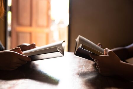 Christians are congregants join hands to pray and seek the blessings of God, the Holy Bible.の写真素材
