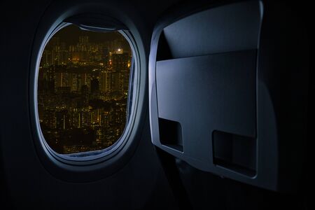 Image save-path for window of airplane. Beautiful scenic city view of night through the aircraft window. の写真素材