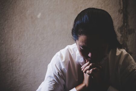 Hand praying to God asian woman pray for blessings from God. Religious concepts.