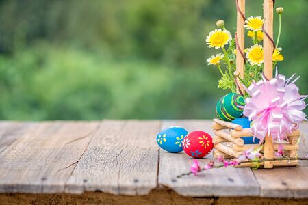 Basket of easter eggs on green nature background  at sunny day.