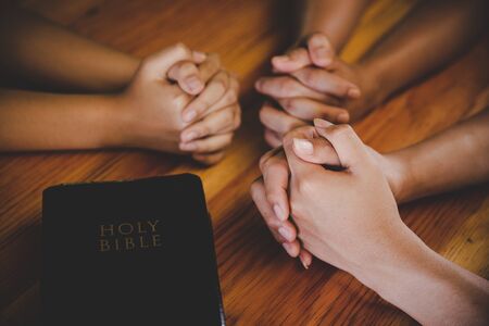 Christian family worship God in home, Holy bible on wooden table concept for faith, spirituality, worship and religion.の写真素材