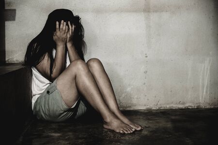 stressful and hopeless woman sitting on ground, abuse concept