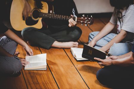 Group of people praying worship believe. soft focus, praying and praise together at home. devotional...