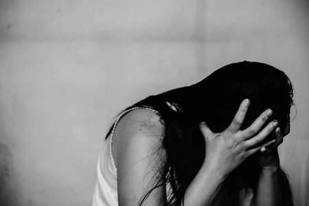 stressful and hopeless woman sitting on ground, abuse conceptの写真素材