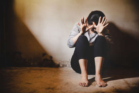 A woman sitting alone and depressed. The depression woman sit on the floor, abuse and people...