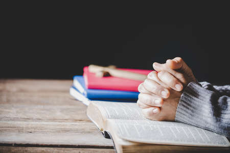 Christian life crisis prayer to god. Woman Pray for god blessing to wishing have a better life. woman hands praying to god with the bible. begging for forgiveness and believe in goodness.の写真素材