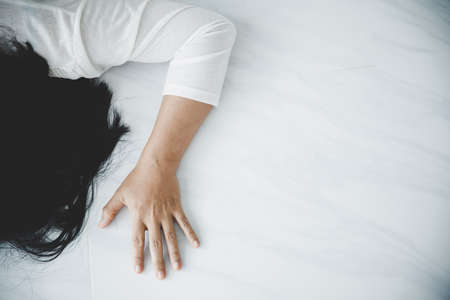 Young depressed woman, domestic and rape violence, beaten and raped on floorの写真素材