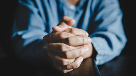 Hands folded in prayer on a Holy Bible in church concept for faith, spirituality and religion, woman praying on holy bible in the morning. woman hand with Bible praying.の写真素材