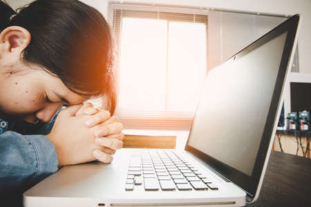 Woman girl stay at home pray and worship GOD with laptop. Prayer girl worship and pray from home for...