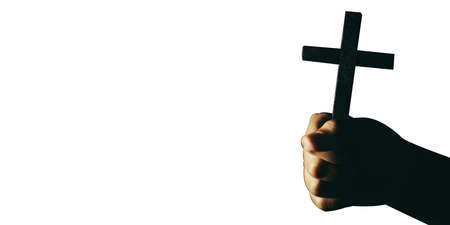 Banner panorama of human hand holding cross with isolated background. christian conceptの写真素材