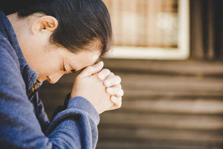 Woman hands praying to god. Woman Pray for god blessing to wishing have a better life. begging for forgiveness and believe in goodness. Christian life crisis prayer to godの写真素材