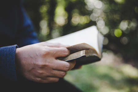 Christian woman holds bible in her hands. Concept for faith, spirituality and religion. Peace, hope.の写真素材
