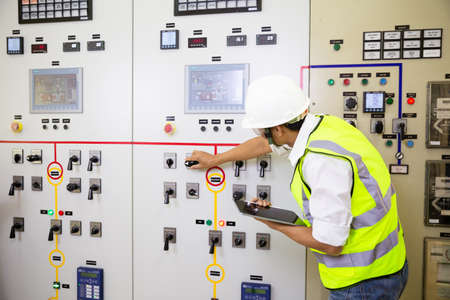 Electrician engineer work at Relay protection system. Bay control unit. Medium voltage switchgear.の写真素材