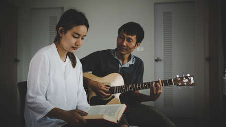 Christian family groups praying with Holy Bible. and play guitar to sing worship thanksgiving...