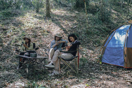 camping tent camp in nature happy friends at nature forest, hike concept. active spending time in mountainsの写真素材