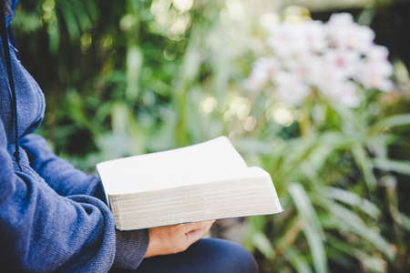 Christian woman reading bible in her hands. Concept for faith, spirituality and religion. Peace,...