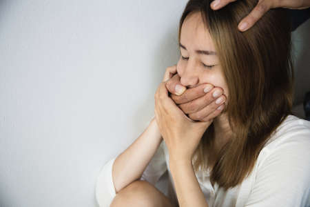 Closeup of a mans hand covering a womans mouth  stop violence against Women, international women's...