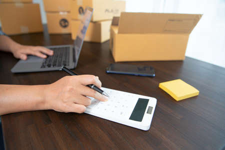 Small entrepreneurs start their SME business at home by arranging their products in parcel boxes....