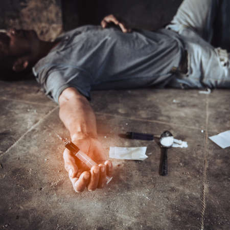 Man are drug addicts to inject heroin into their veins themselves.Flakka drug or zombie drug is dangerous life-threatening,Thailand no to drug concept,The bad guy drugs in the desolateの写真素材