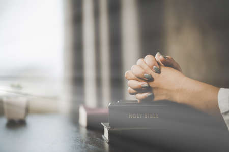 A woman praying worship believe. soft focus, praying and praise together at home. devotional or...