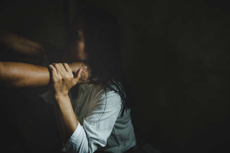 Aggression in the family, man beating up his wife. Domestic violence concept.の写真素材