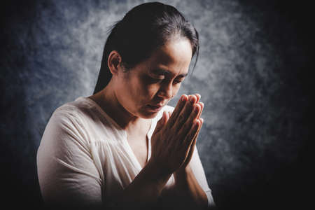 Christian life crisis prayer to god. Woman Pray for god blessing to wishing have a better life. woman hands praying to god with the bible. begging for forgiveness and believe in goodness.の写真素材