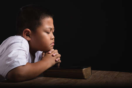 Boy praying to God at home, World Day of Prayer, international day of prayer, hope, gratitude, thankful, trustの写真素材