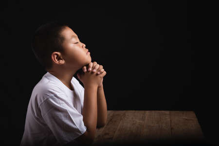 Boy praying to God at home, World Day of Prayer, international day of prayer, hope, gratitude, thankful, trustの写真素材