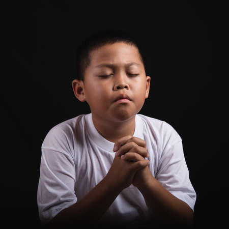 Boy praying to God at home, World Day of Prayer, international day of prayer, hope, gratitude, thankful, trustの写真素材