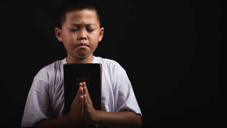 Boy praying to God at home, World Day of Prayer, international day of prayer, hope, gratitude, thankful, trustの写真素材