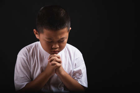 Boy praying to God at home, World Day of Prayer, international day of prayer, hope, gratitude, thankful, trustの写真素材