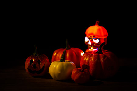 Halloween pumpkin head jack lantern with burning candles. Pumpkins in graveyard in the spooky night...