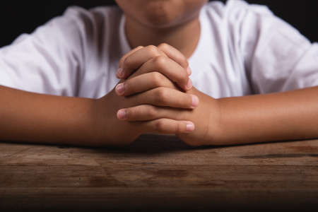 Boy praying to God at home, World Day of Prayer, international day of prayer, hope, gratitude, thankful, trustの写真素材