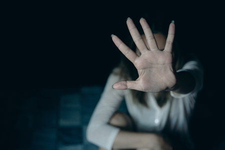 Stop hurting woman! young female person raised her hand for stop violence, sexual abuse, human trafficking, domestic violence and rape, International Day for the Elimination of Violence against Womenの写真素材