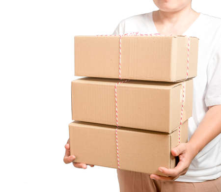 A parcel cardboard parcel box in a delivery woman person hands isolated on white background....
