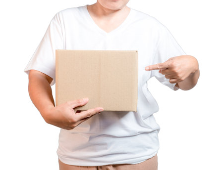 A parcel cardboard parcel box in a delivery woman person hands isolated on white background. Delivery service concept. Asian Young girl holding a package is a delivery business entrepreneur.の写真素材