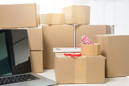 Equipments for SME online business, delivery business laptop, barcode, boxes, checking product on stocks or cardboard parcels. Small business working at home office. delivery service product at home.の写真素材