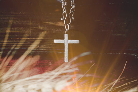 Holy bible book with cross or crucifix on old black wooden background. Christian catholic with protestant pray and study in church. Concept of cognition about faith god and religion, jesus spiritual.の写真素材