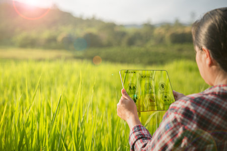 Agriculture technology farmer holding digital tablet or tablet technology to research about...
