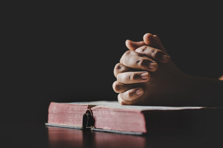 Young woman person hand holding holy bible with study at home. Adult female christian reading book in church. Girl learning religion spirituality with pray to god. concept of student education faith.の写真素材