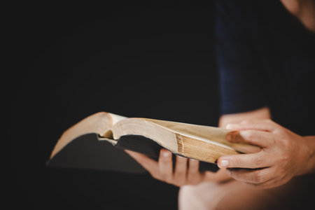 Young woman person hand holding holy bible with study at home. Adult female christian reading book in church. Girl learning religion spirituality with pray to god. concept of student education faith.の写真素材