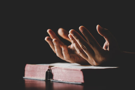 Young woman person hand holding holy bible with study at home. Adult female christian reading book in church. Girl learning religion spirituality with pray to god. concept of student education faith.の写真素材