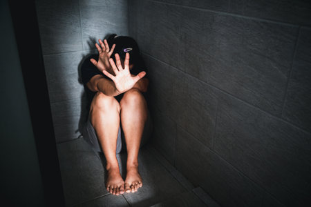 Stop harassment violence concept. Boss or employer sexually harassed a business woman at work. Depressed girl sitting in corner. stop violence against Women, international women's day.の写真素材