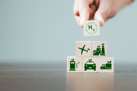 Free Carbon, alternative energy and global climate change concepts. Hand flipping wooden cube blocks with CO2 Carbon dioxide, change to H2 Hydrogen text on table background. Sustainable car energy.の写真素材