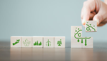 Companies are targeting net zero greenhouse gas emissions. Carbon credit concept.Tradable certificate to drive industry in direction of low emissions in efficiency cost. Wooden cubes with decrease CO2の写真素材
